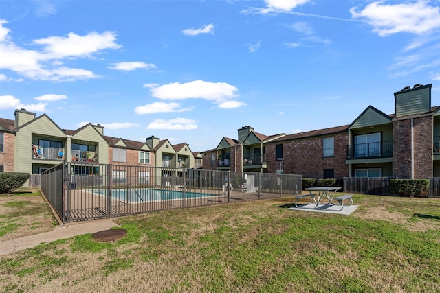 view of pool with a yard and a patio