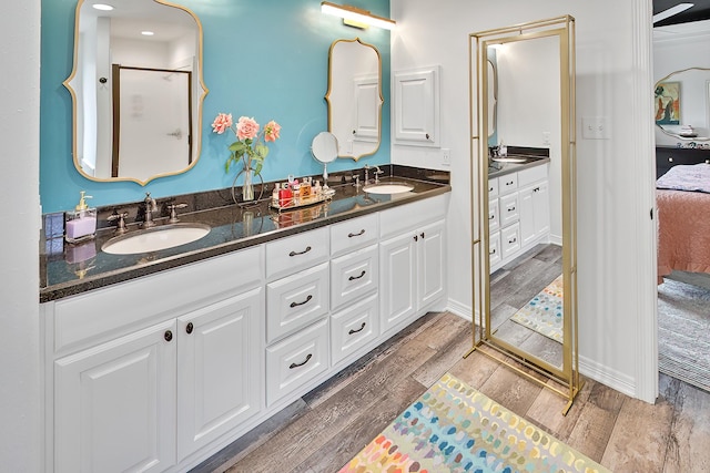 bathroom featuring wood-type flooring, vanity, and an enclosed shower