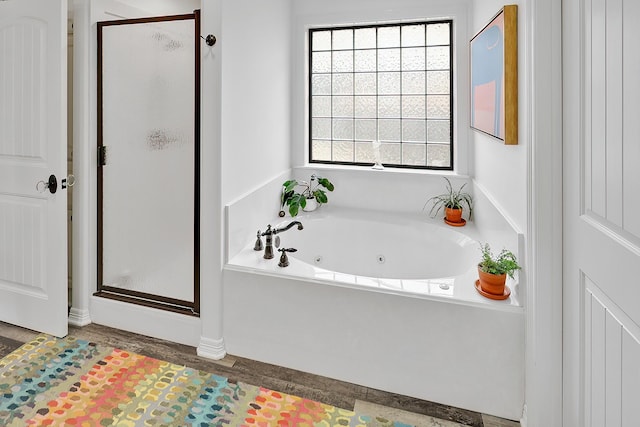 bathroom featuring shower with separate bathtub