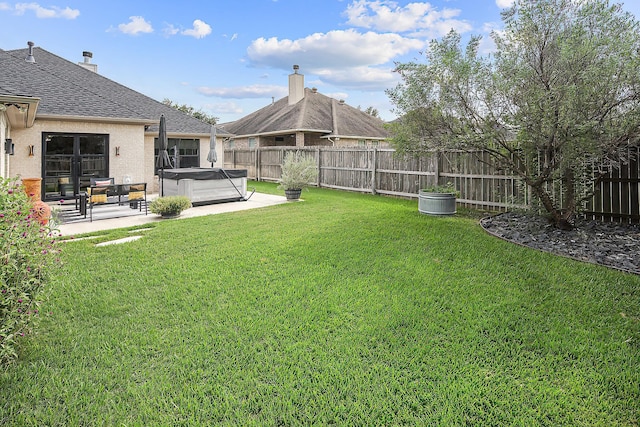 view of yard with a patio and a hot tub