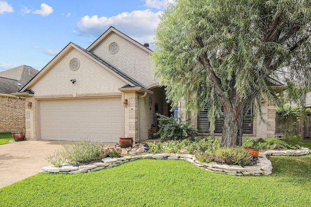 view of front of house with a garage and a front lawn