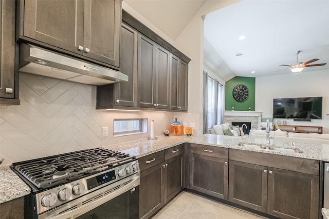 29614 Sterling Knoll Dr, Fulshear, TX 77441 - kitchen featuring dark brown cabinetry, ceiling fan, stainless steel gas range oven, range hood, and a sink