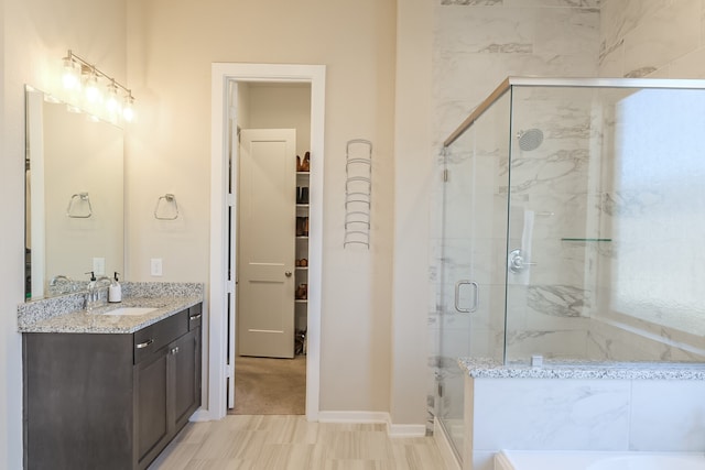 29614 Sterling Knoll Dr, Fulshear, TX 77441 - full bath with baseboards, a shower stall, a bathtub, and vanity