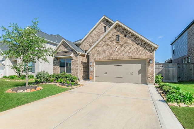29614 Sterling Knoll Dr, Fulshear, TX 77441 - view of front of home with fence, an attached garage, a front lawn, brick siding, and concrete driveway