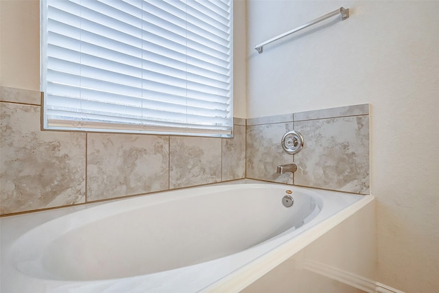 bathroom featuring a tub to relax in