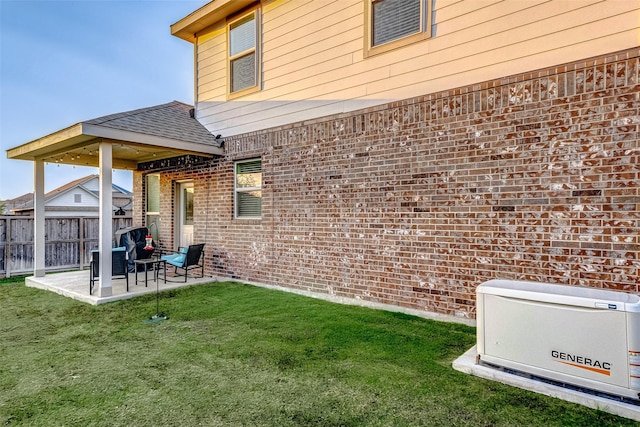 rear view of house with a yard and a patio