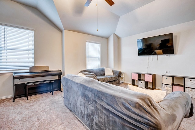 carpeted living room with ceiling fan and lofted ceiling