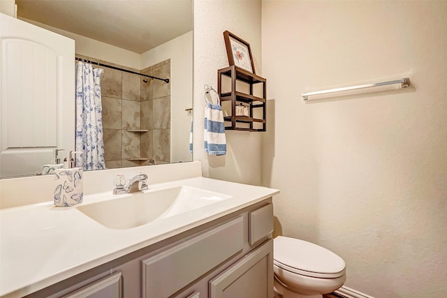 bathroom featuring a shower with curtain, vanity, and toilet