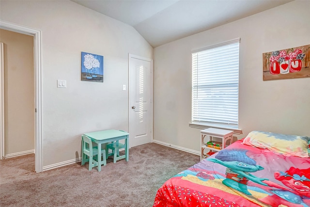 bedroom with carpet floors and vaulted ceiling