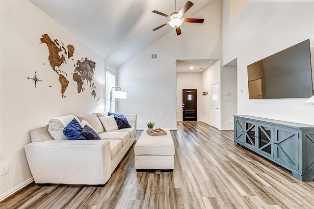 living room featuring ceiling fan, high vaulted ceiling, wood finished floors, visible vents, and baseboards