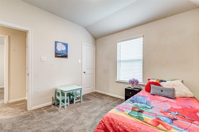 bedroom with vaulted ceiling, dark colored carpet, and baseboards