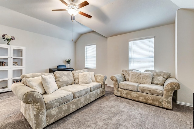 carpeted living room featuring vaulted ceiling, baseboards, and ceiling fan