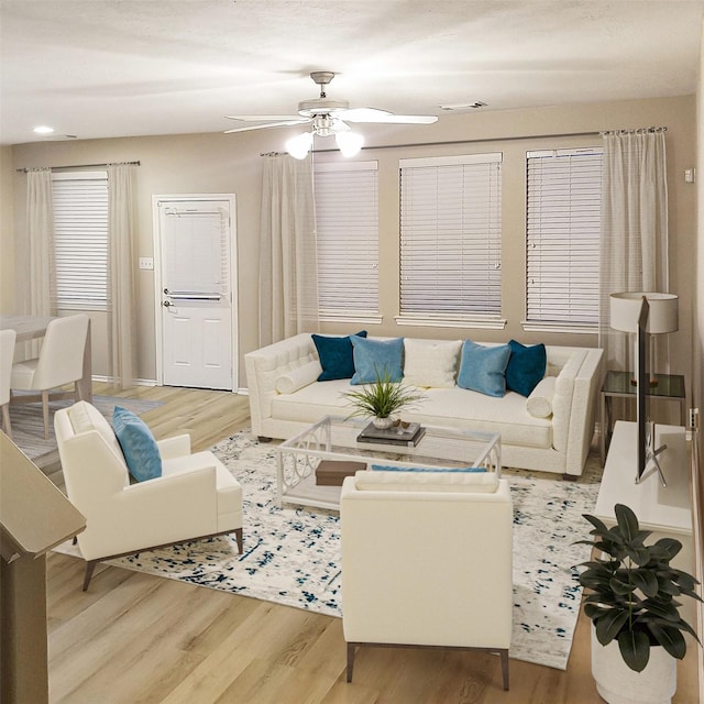 living room with ceiling fan and light wood-type flooring