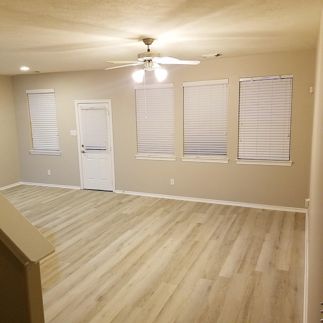 spare room featuring ceiling fan and light hardwood / wood-style flooring