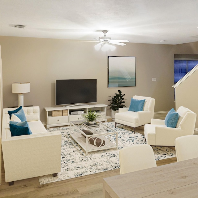 living room with ceiling fan and hardwood / wood-style flooring