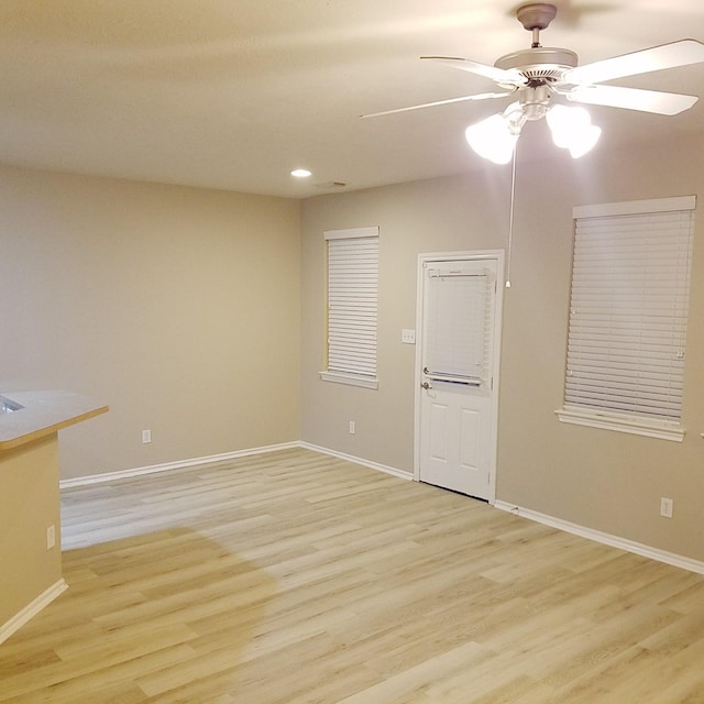 empty room with light wood-type flooring and ceiling fan