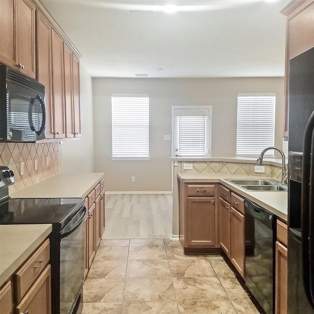 kitchen with sink, backsplash, and black appliances