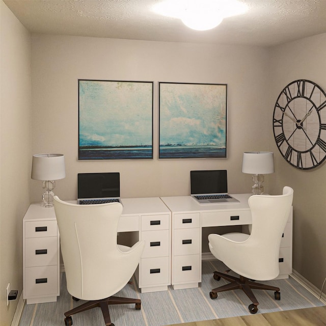 office space featuring light hardwood / wood-style flooring and a textured ceiling