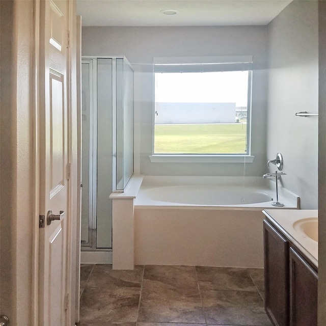 bathroom with vanity and independent shower and bath