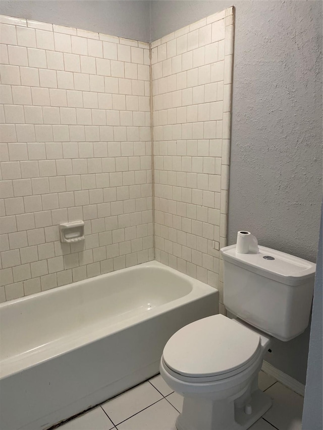 bathroom featuring toilet, tile patterned flooring, and shower / washtub combination