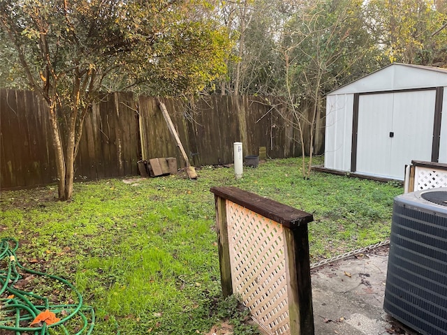 view of yard featuring central AC and a storage shed