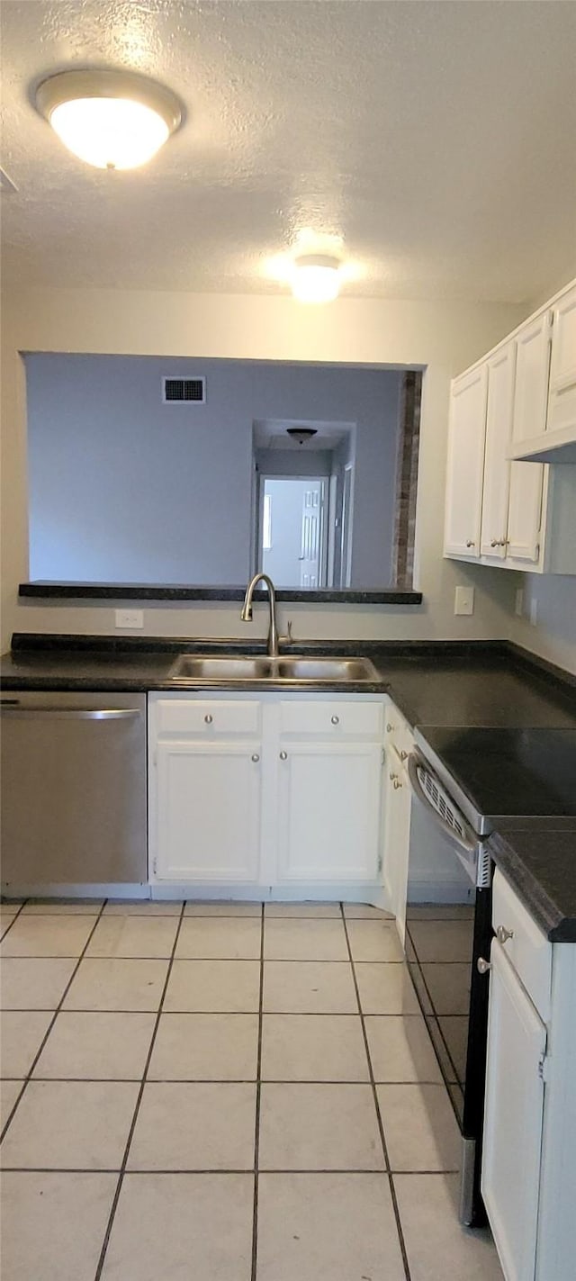 kitchen with electric range, sink, white cabinetry, stainless steel dishwasher, and light tile patterned flooring