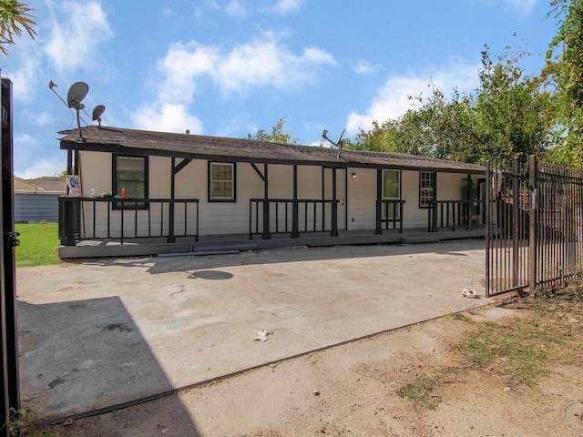 back of property featuring covered porch