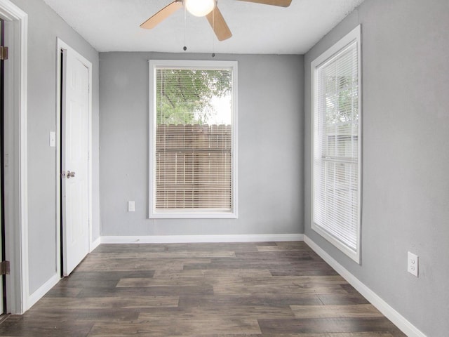 spare room featuring ceiling fan and dark hardwood / wood-style flooring