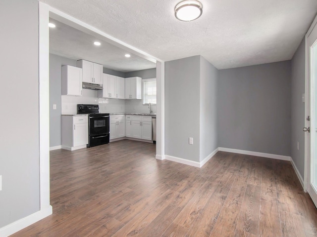 kitchen featuring white cabinetry, sink, dark hardwood / wood-style floors, black / electric stove, and a textured ceiling