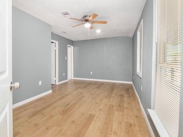 unfurnished bedroom with ceiling fan and light hardwood / wood-style flooring