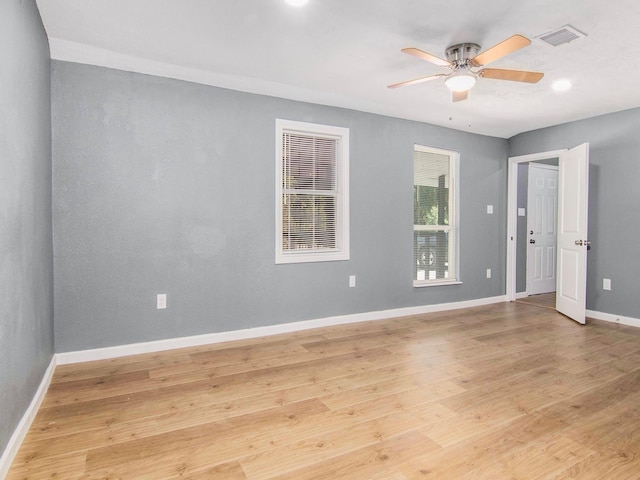 empty room featuring ceiling fan and light hardwood / wood-style flooring