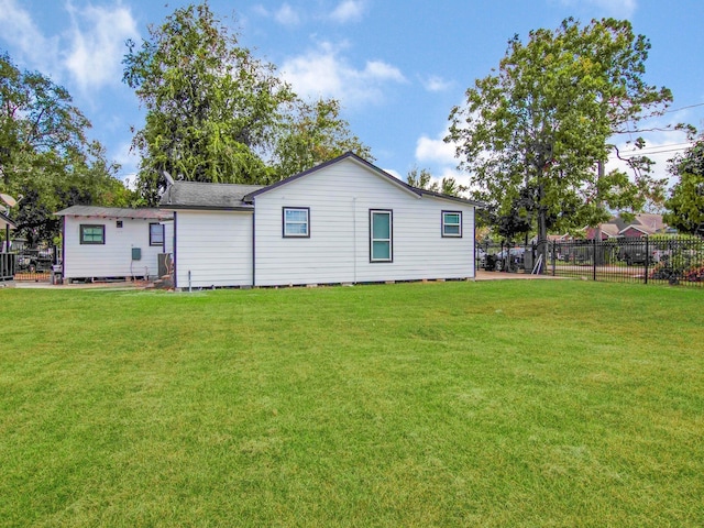 rear view of property with a lawn