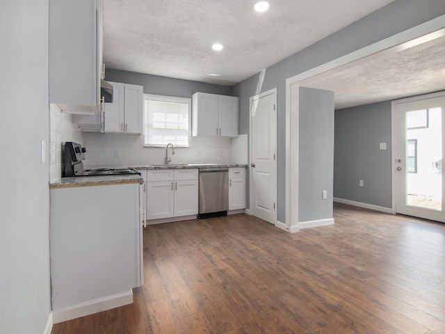 kitchen featuring white cabinetry, dishwasher, sink, decorative backsplash, and range