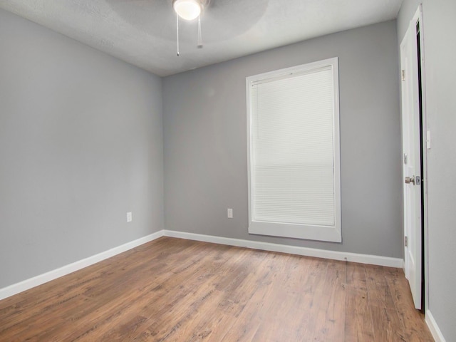 empty room featuring hardwood / wood-style floors and ceiling fan