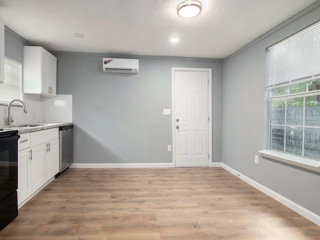 kitchen with dishwasher, sink, tasteful backsplash, white cabinetry, and a wall unit AC