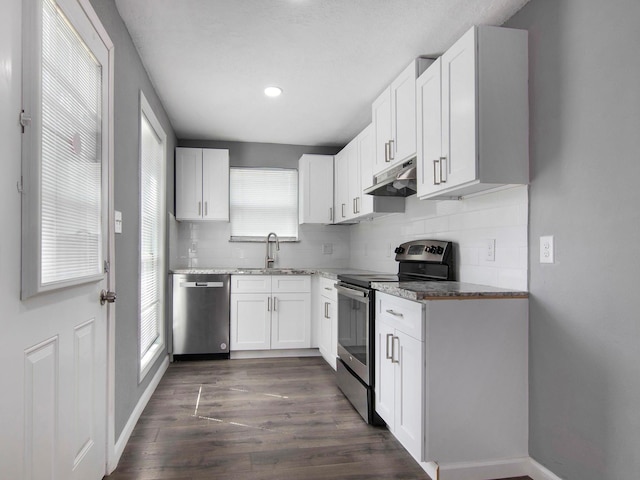 kitchen featuring backsplash, white cabinetry, dark hardwood / wood-style flooring, and stainless steel appliances