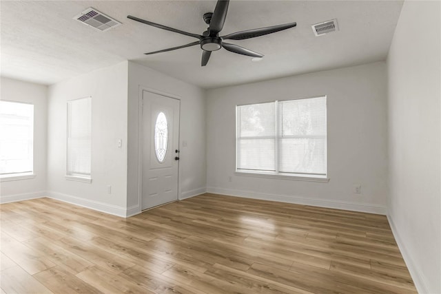 foyer entrance featuring plenty of natural light, ceiling fan, and light hardwood / wood-style flooring