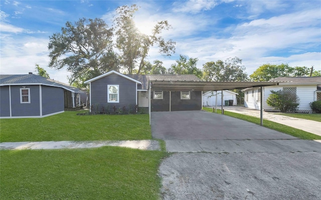 ranch-style home with an outbuilding, a front yard, and a carport