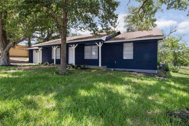 ranch-style house with a garage and a front lawn