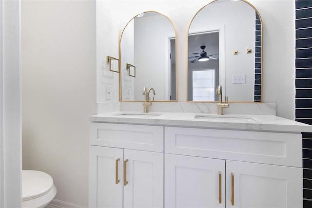 bathroom with ceiling fan, toilet, and vanity