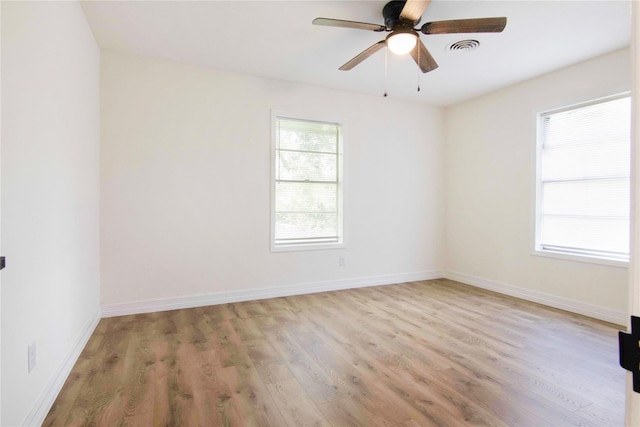 spare room with ceiling fan and light wood-type flooring