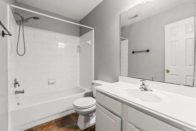 full bathroom featuring vanity, toilet, and tiled shower / bath