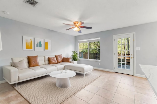 tiled living room featuring ceiling fan