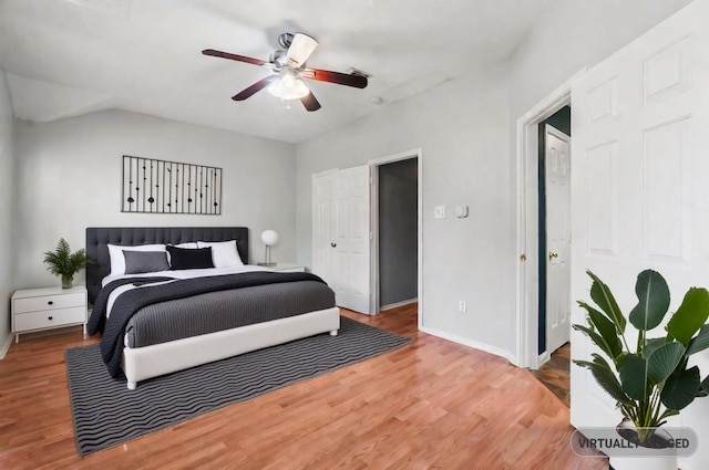 bedroom with ceiling fan, a closet, and wood-type flooring