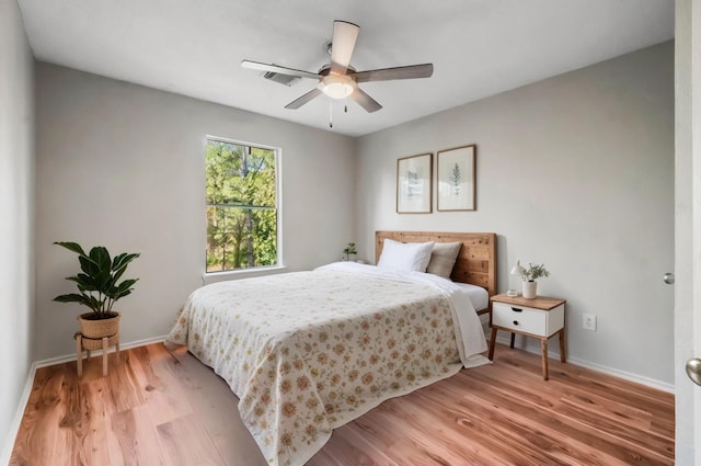 bedroom with ceiling fan and light hardwood / wood-style floors