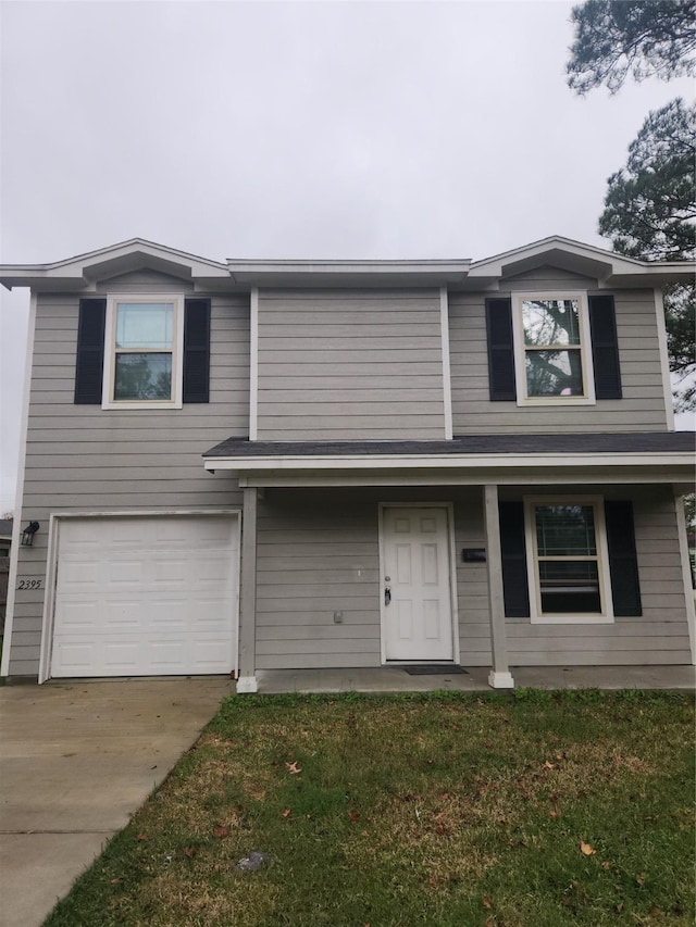 view of front facade with a front lawn and a garage