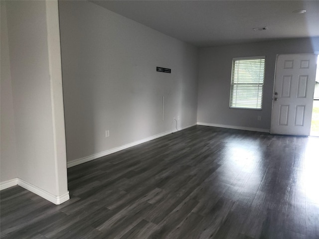 unfurnished room with dark hardwood / wood-style floors