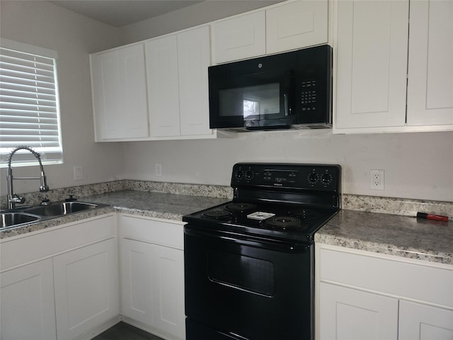 kitchen with black appliances, white cabinetry, and sink