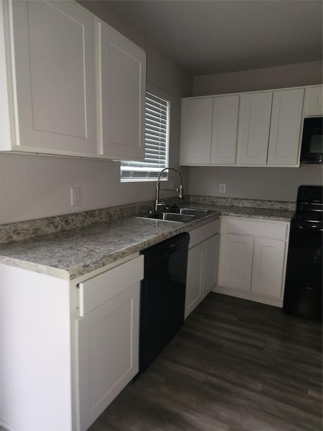 kitchen with white cabinets, dark hardwood / wood-style flooring, sink, and black appliances