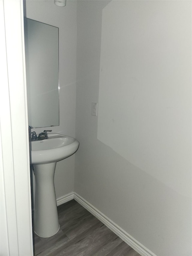 bathroom with hardwood / wood-style floors and sink